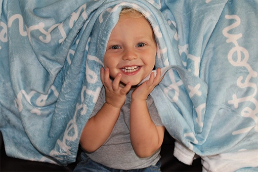 Product photography of custom name blanket from Three Arrow Collective